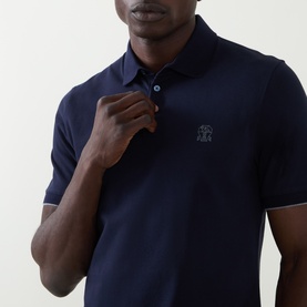 Model wearing Brunello Cucinelli Logo Pique Polo Shirt in Cadet navy, featuring tonal logo embroidery and button collar, short sleeves