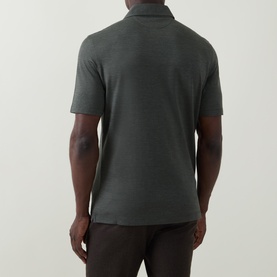 Model wearing B Cucinelli Solid Knitted Polo Shirt in Military Green, rear view, polo collar, short sleeves, straight hem