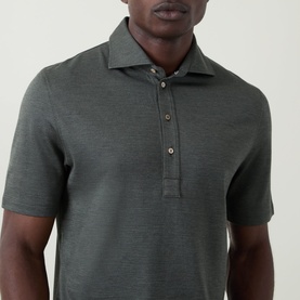 Model wearing B Cucinelli Solid Knitted Polo Shirt in Military Green, with polo collar and three-button placket, cropped at torso.