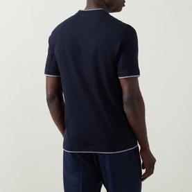 Model wearing B Cucinelli Contrast Trim Jersey T-Shirt in navy, rear view showing white contrast trim at collar, cuffs and hem.