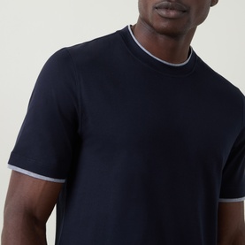 Model wearing B Cucinelli Contrast Trim Jersey T-Shirt in navy with grey contrast ribbed crewneck and sleeve cuffs