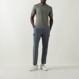 Model wearing B Cucinelli Contrast Trim Jersey T-Shirt in Dark Green with grey cargo trousers and white trainers.