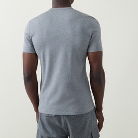 Model wearing B Cucinelli Solid Regular Fit T-Shirt in mid grey, back view, round neck, short sleeves, paired with grey cargo shorts.