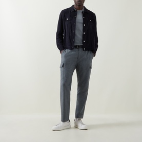 Model wearing Brunello Cucinelli Mid Grey Solid Regular Fit T-Shirt, styled with navy jacket, grey cargo trousers and white trainers.