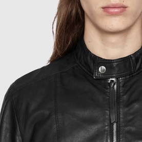 Model wearing All Saints black leather biker jacket, close-up of collar and zip detail