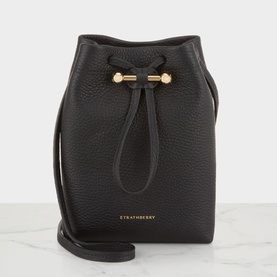 Strathberry Osette Midi Pouch Bag in black grained calf leather, gold-tone Music Bar drawstring hardware, narrow crossbody strap