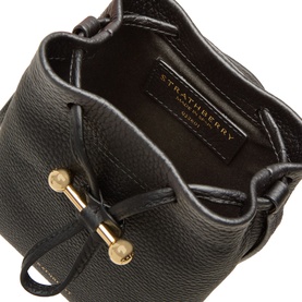 Strathberry Osette Midi Pouch Bag in black grained calf leather, viewed from above showing drawstring interior and gold-tone Music Bar hardware.