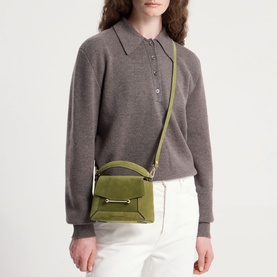 Model carrying Strathberry Mosaic Nano Top Handle Bag in Lime/Khaki suede with gold-tone hardware and crossbody strap, styled with grey polo and