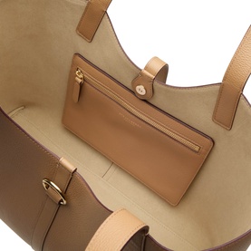Strathberry Kite Leather Tote Bag in caramel grained calf leather, showing interior zip pocket and gold-tone hardware detail