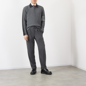 Model wearing Thom Browne Tonal Grey wool polo with signature 4-bar stripe, styled with matching grey trousers and black loafers.