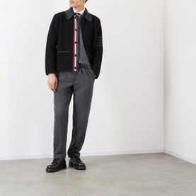 Model wearing Thom Browne Tonal Grey wool polo with black jacket, grey trousers and black loafers.