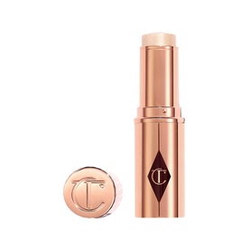 Charlotte Tilbury Unreal Highlighter Stick in Glazed Goddess, rose gold twist-up stick with branded cap
