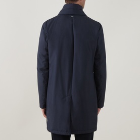 Model wearing Herno Blu Navy padded coat, rear view showing clean back seam and high collar