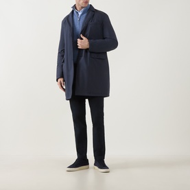 Model wearing Herno Blu Navy coat with notch lapel, styled with light blue shirt, dark trousers and navy suede loafers