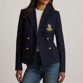 Model wearing Lauren navy double-breasted blazer with gold crest emblem and gold buttons, styled with white top and blue jeans