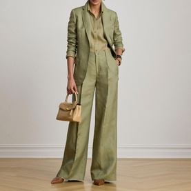 Model wearing Lauren Light Agave blazer with matching wide-leg trousers and olive shirt, carrying a small tan handbag