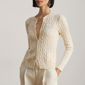Model wearing Lauren Mascarpone Cream cable-knit cardigan with button front, styled with cream wide-leg trousers