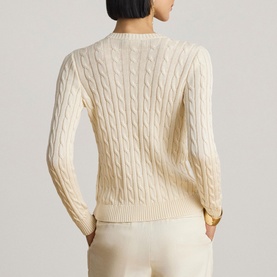 Model wearing Lauren Mascarpone Cream cable-knit cardigan, shown from the back, styled with cream trousers