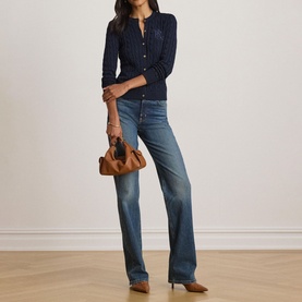 Model wearing Lauren navy cardigan with wide-leg blue jeans, styled with tan heels and a brown mini bag.