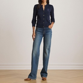 Model wearing Lauren navy cable-knit cardigan with button front, styled with wide-leg light wash jeans and brown heeled mules.