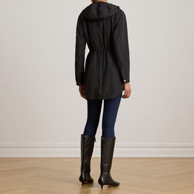 Model wearing Lauren black hooded coat with drawstring waist, styled with dark jeans and black knee-high boots, back view