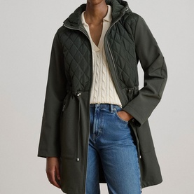 Model wearing Lauren coat in Litchfield Loden, quilted hood panel detail, cinched waist, styled with cream knit and blue jeans
