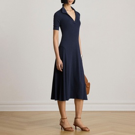 Model wearing Lauren navy midi dress with V-neck polo collar and short sleeves, styled with tan heeled sandals and clutch bag