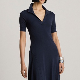 Model wearing Lauren navy knit polo dress with short sleeves and open collar, styled with silver cuff bracelets