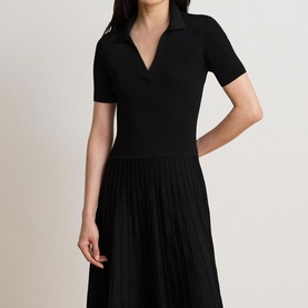 Model wearing Lauren black short-sleeve knit dress with V-notch collar and pleated midi skirt