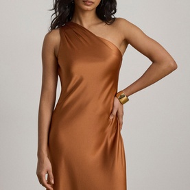 Model wearing Lauren Red Terracotta satin one-shoulder mini dress, styled with a gold cuff bracelet