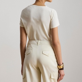 Model wearing Lauren Mascarpone Cream knit top, back view, paired with cream cargo trousers and gold cuff bracelet