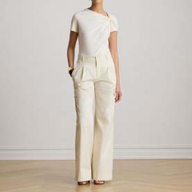 Model wearing Lauren Mascarpone Cream asymmetric knot-detail knit top, styled with wide-leg cream cargo trousers