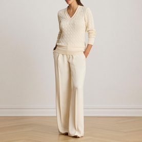 Model wearing Lauren Mascarpone Cream cable-knit V-neck jumper, styled with matching wide-leg trousers