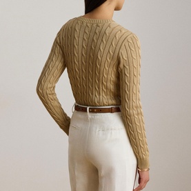 Model wearing Lauren Birch Tan cable-knit sweater, back view, styled with white trousers and brown leather belt