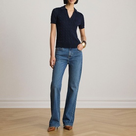 Model wearing Lauren navy short-sleeve ribbed polo knit top, styled with light blue wide-leg jeans and brown heeled mules