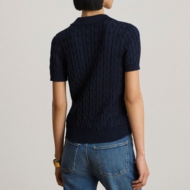 Model wearing Lauren navy cable-knit short-sleeve polo top, back view, styled with light blue jeans and a gold bangle.
