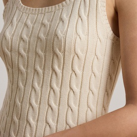 Model wearing Lauren cable-knit sleeveless top in Mascarpone Cream, close-up detail of textured knit pattern