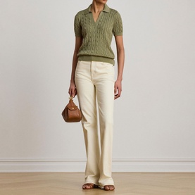 Model wearing Lauren Light Agave cable-knit polo top with cream wide-leg trousers, carrying a tan mini bag.