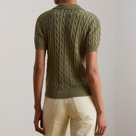 Model wearing Lauren Light Agave cable-knit short-sleeve polo top, back view, styled with cream wide-leg trousers.