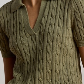 Model wearing Lauren cable-knit polo top in Light Agave, close-up detail showing short sleeves and open collar