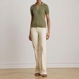 Model wearing Lauren Light Agave cable-knit polo top with short sleeves, styled with cream wide-leg trousers