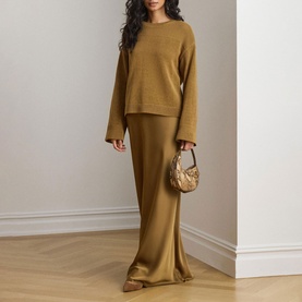 Model wearing Lauren Tobacco Bronze knit sweater with matching maxi skirt and small snake-print bag