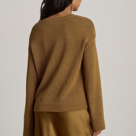 Model wearing Lauren Tobacco Bronze knit sweater, back view, with relaxed fit and ribbed hem, styled with satin skirt