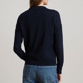Model wearing Lauren navy knit jumper, back view, styled with blue denim jeans