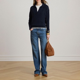 Model wearing Lauren navy half-zip knit jumper, styled with blue wide-leg jeans and carrying a tan leather bag.