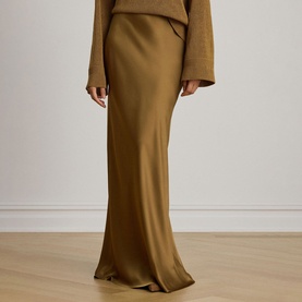 Model wearing Lauren skirt in Tobacco Bronze, maxi length with fluid satin finish, styled with matching long-sleeve top