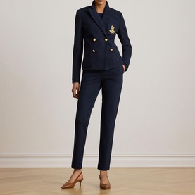 Model wearing Lauren navy slim-leg trousers, styled with a matching navy double-breasted blazer and tan heels.
