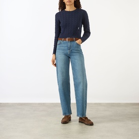 Model wearing Sporty and Rich Dark Navy ribbed knit top with wide-leg blue jeans, brown belt and brown loafers.
