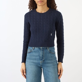 Model wearing Sporty and Rich Dark Navy cable-knit cropped sweater with crew neck, styled with light blue jeans.