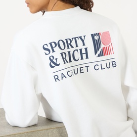 Model wearing Sporty and Rich white sweat, back view showing navy and red Raquet Club graphic print
